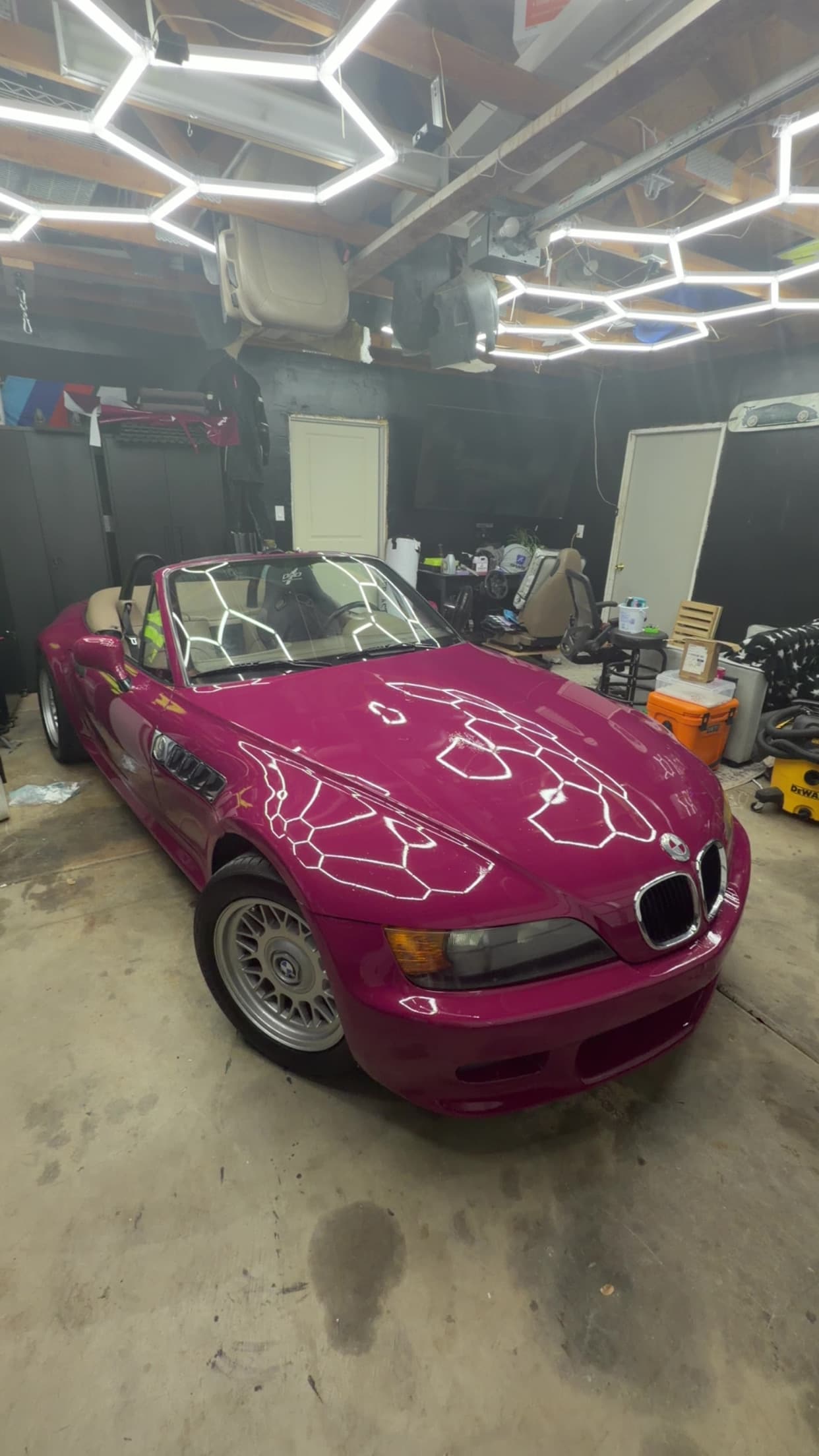 The same Z3 wrapped in RubyStar, parked in the shop under hexagon lights.